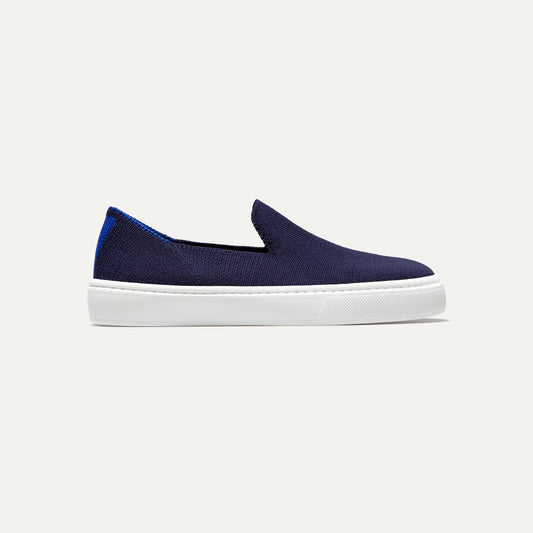 side | The Kids slip-on Sneaker in Deep Navy shown from a side view showing the outsole.