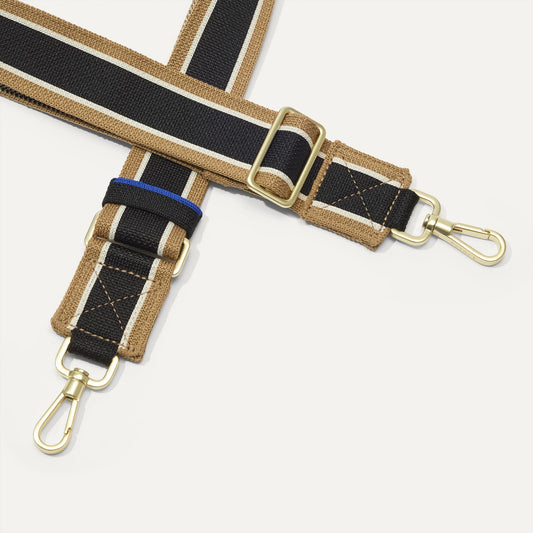 A close-up of The Crossbody Strap in Khaki Stripe, focusing on the end snap hooks and sliding buckle.