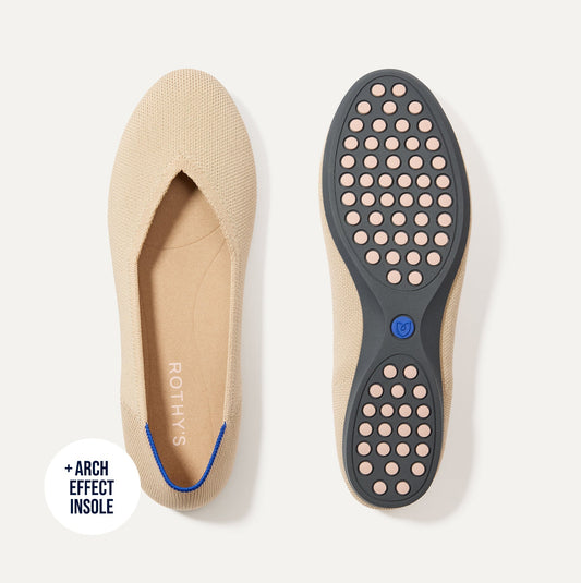 PDP |The Daily Flat in Ecru shown from the top with one shoe showing the outsole.