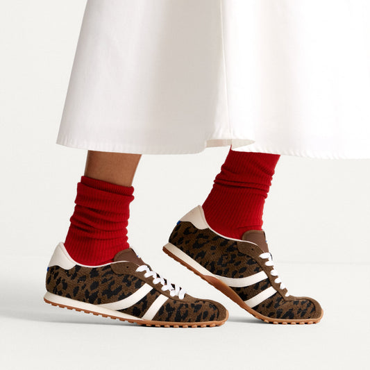 hover | Model wearing The Ivy Sneaker in ReVelvet Cheetah.