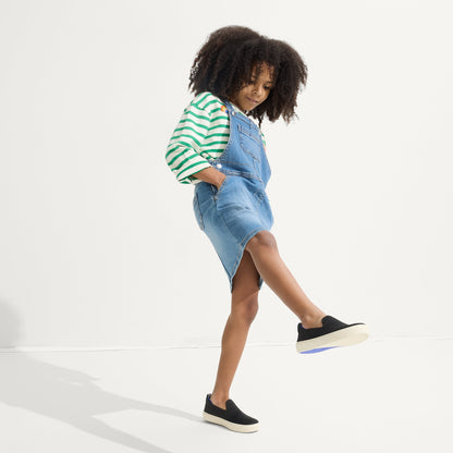 model | Alternate view of a model wearing The Kids Sneaker in Black.