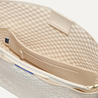 The Bucket Bag in White Sand close up of interior zipper pocket.