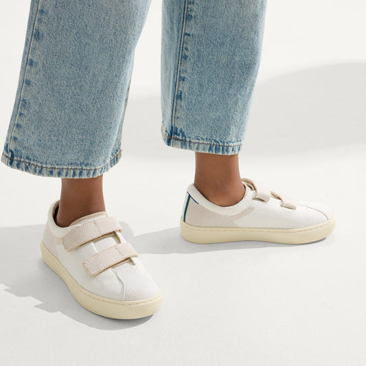 hover | A child modeling The Kids Strap Sneaker in Vanilla Ice.