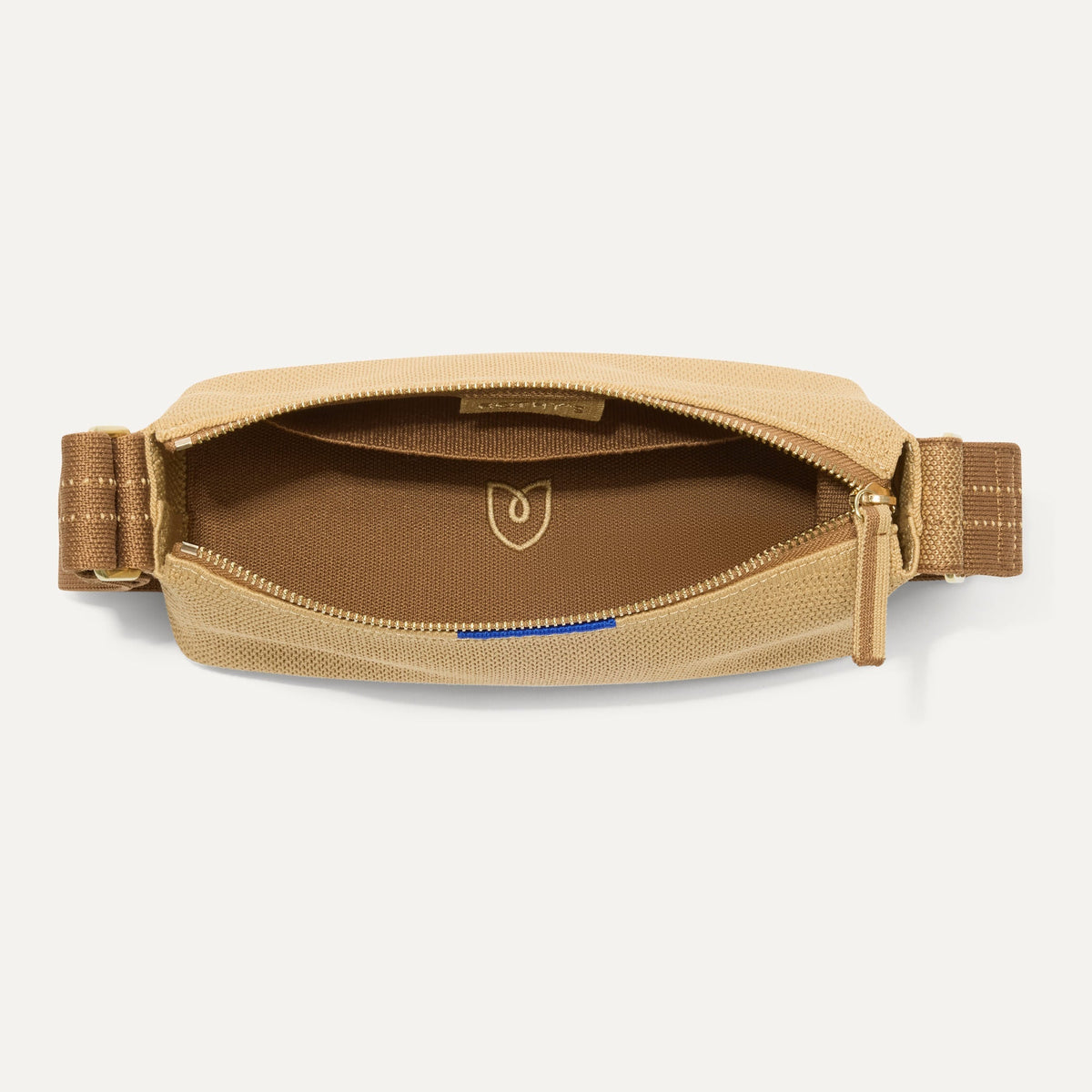 The Casual Crossbody in Brown Butter Raffia-Knit, shown from above, with the interior exposed.