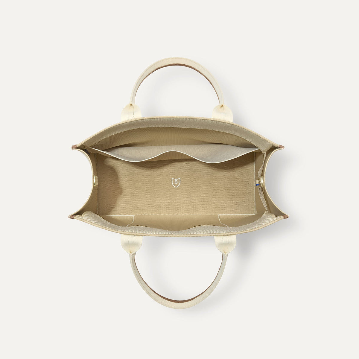 The Classic Tote in Buttercream, shown from above, with the interior exposed.