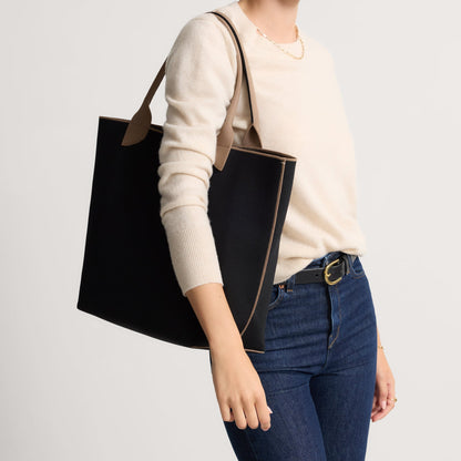 hover | Model holding The Lightweight Tote in Black Portobello.