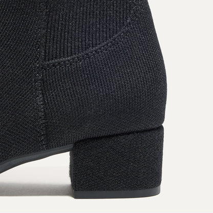 Close up of the block heel of The Classic Boot in Black.