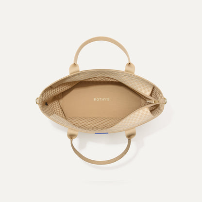 The Zip Travel Tote in Parchment Basketweave, shown from above with the interior exposed.