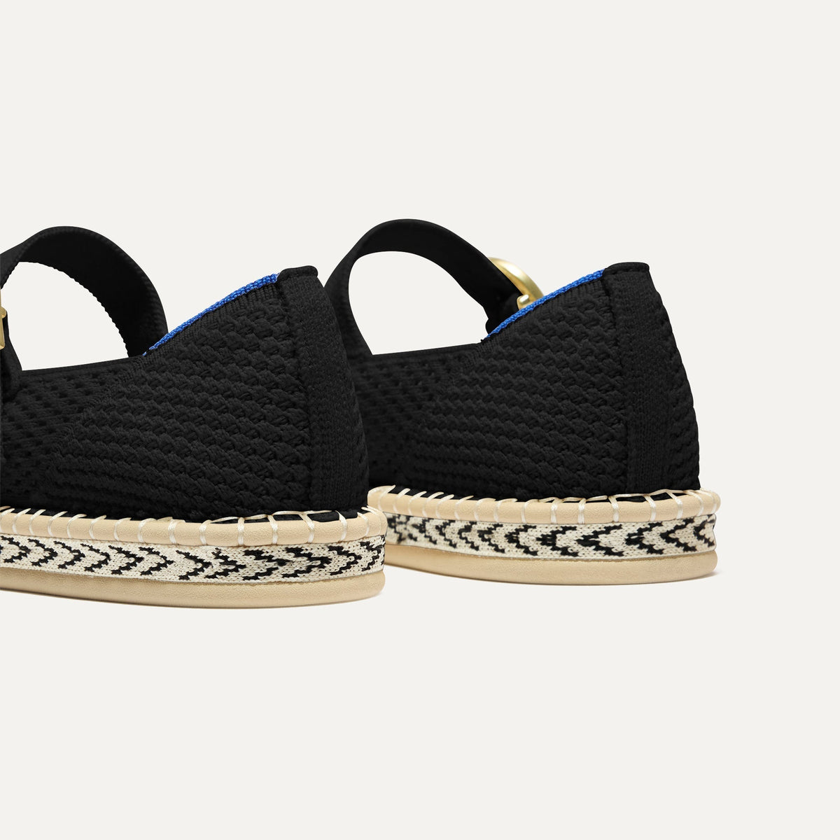 Close up of the heel of The Espadrille Mary Jane in Black, with Rothy's signature blue halo.