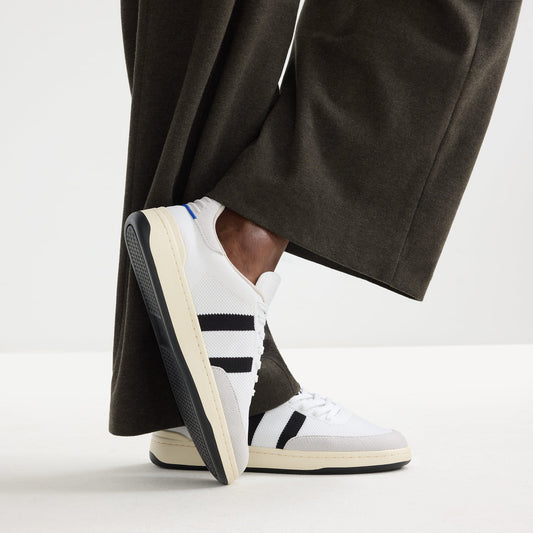 hover | Model wearing The Men's Court Sneaker in Black Drift.