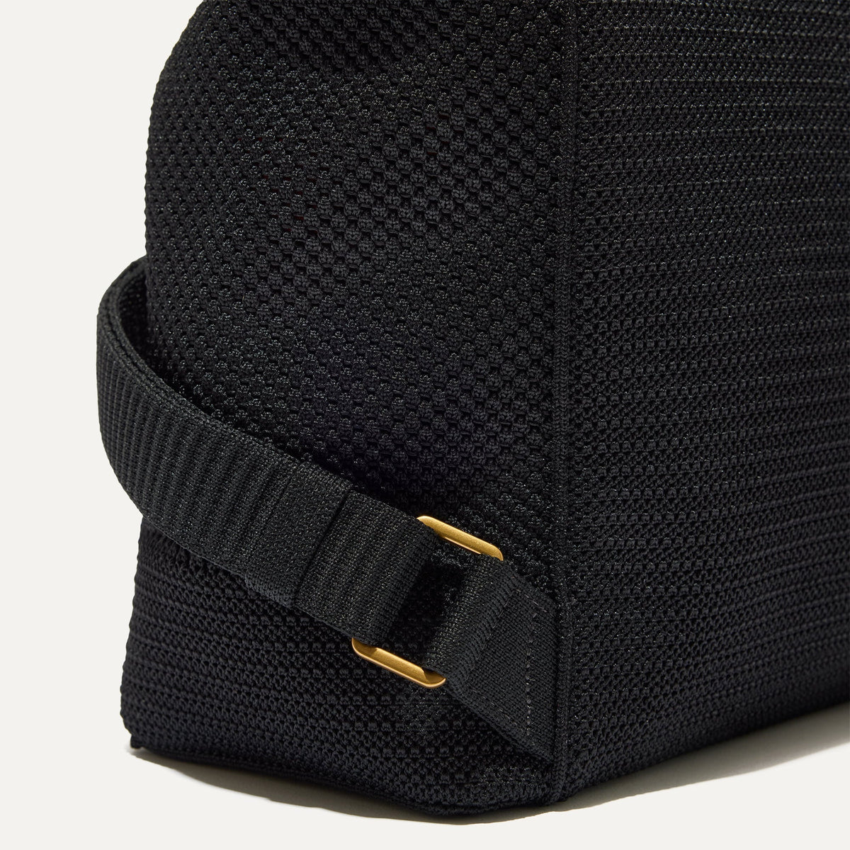 Closer look at the side straps of The Cinch Back Pack in Black.