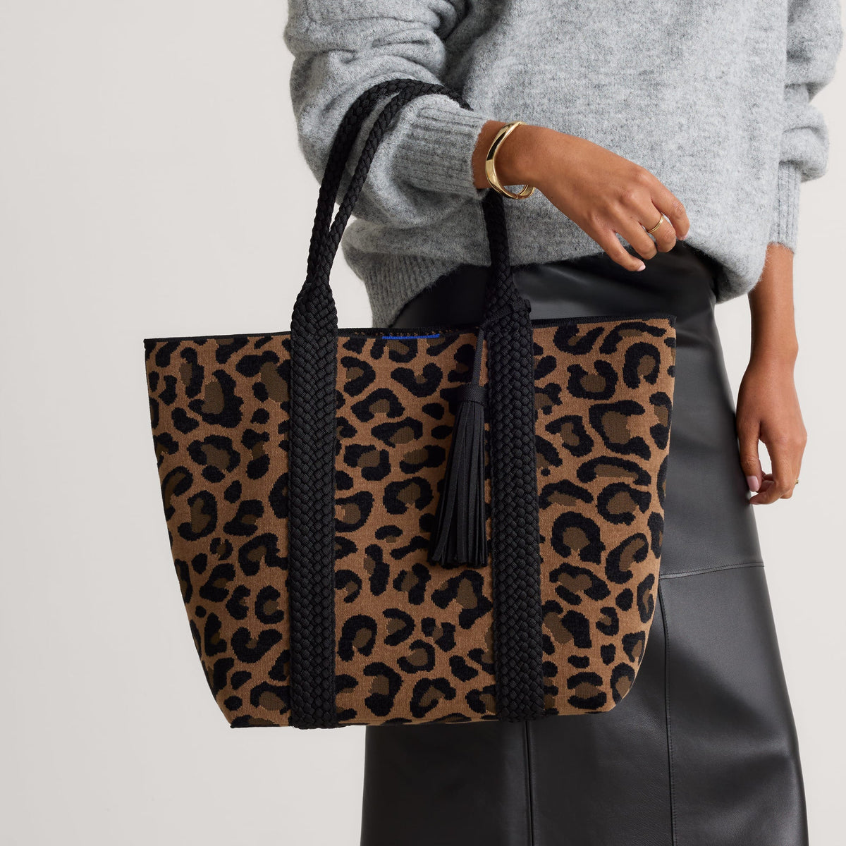 hover | Model holding The Revelvet Lightweight Tote in Revlvet Cat.