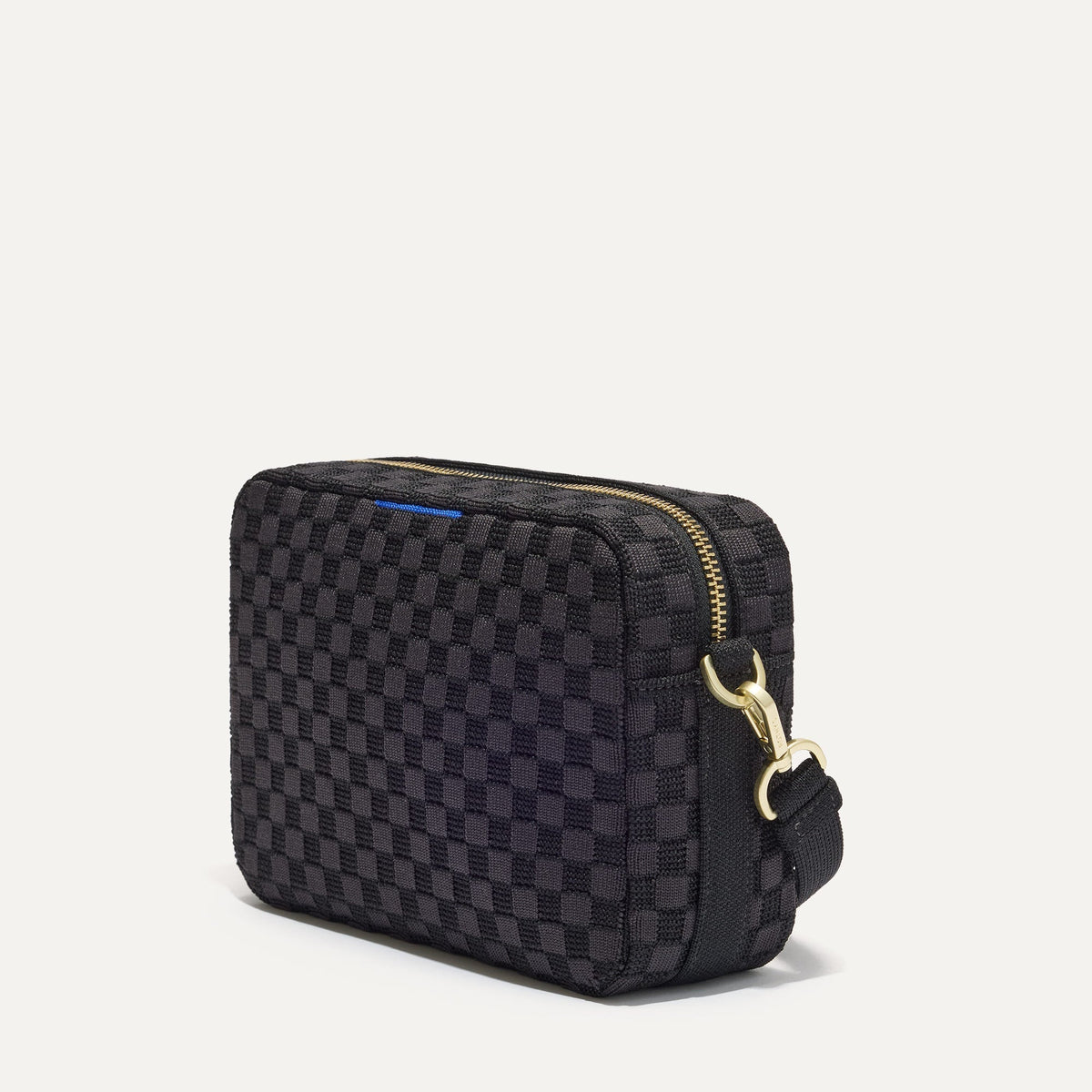 The Crossbody Camera Bag in Black Sand, shown from the side.