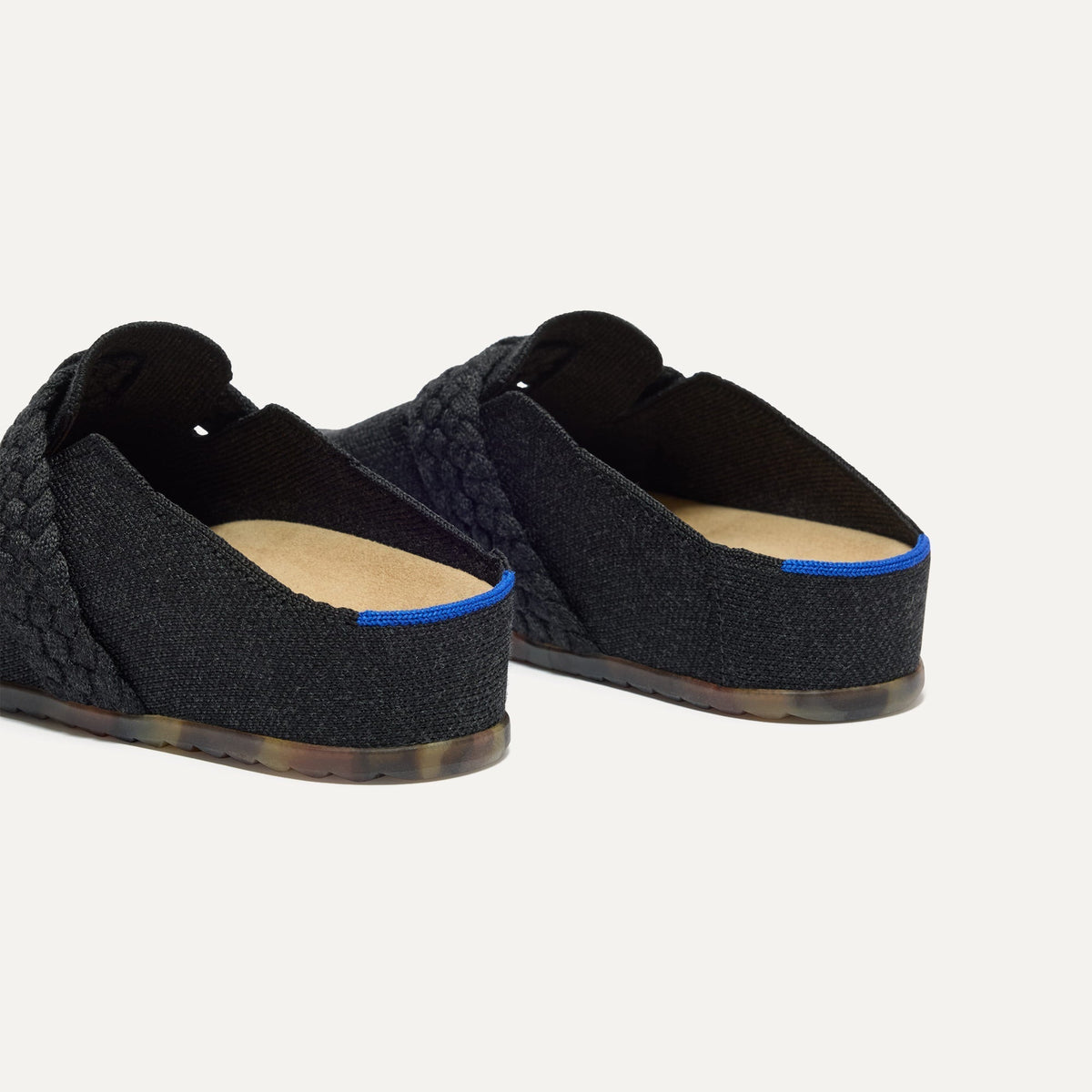 Close up of the heel of The Braid Clog in Black, with Rothy's signature blue halo.