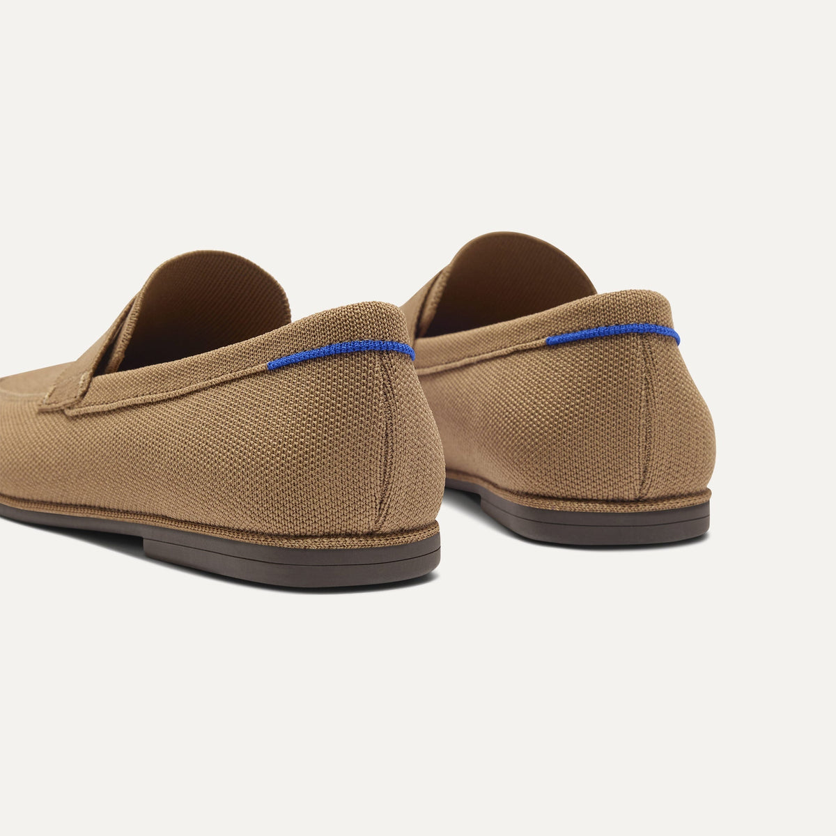 Close up of the heel of The Ravello Penny Loafer in Morel, with Rothy's signature blue halo on the pull tab.