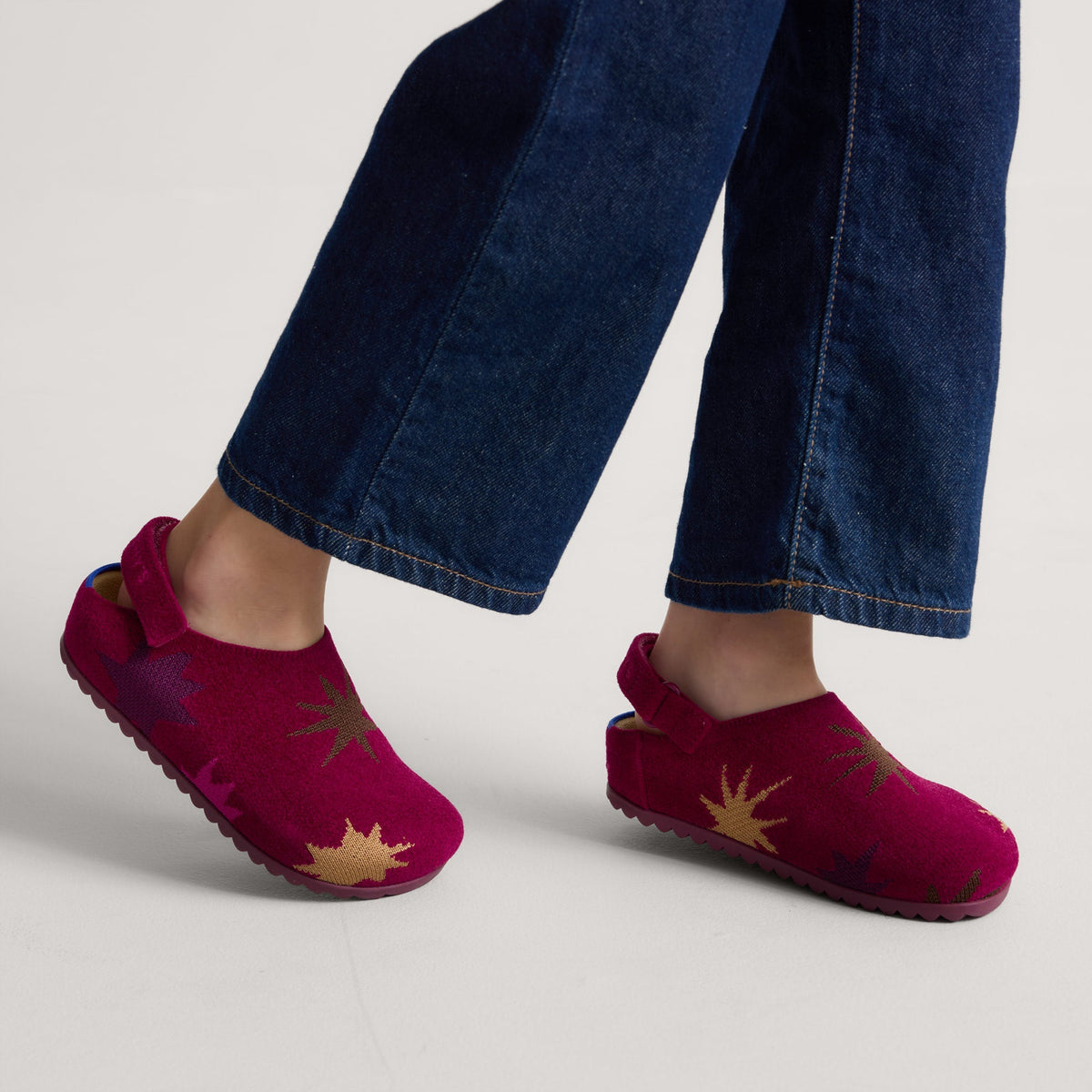 hover | Model wearing The Kids Clog in ReVelvet™ Fuchsia Burst.