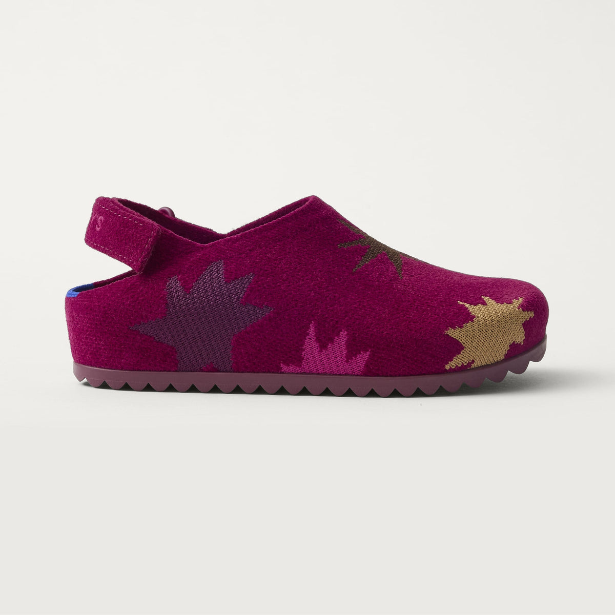 The Kids Clog in ReVelvet™ Fuchsia Burst shown from a side view showing the outsole.