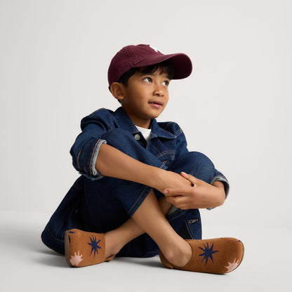 Alternate view of a model wearing The Kids Clog in ReVelvet™ Butterscotch Burst.