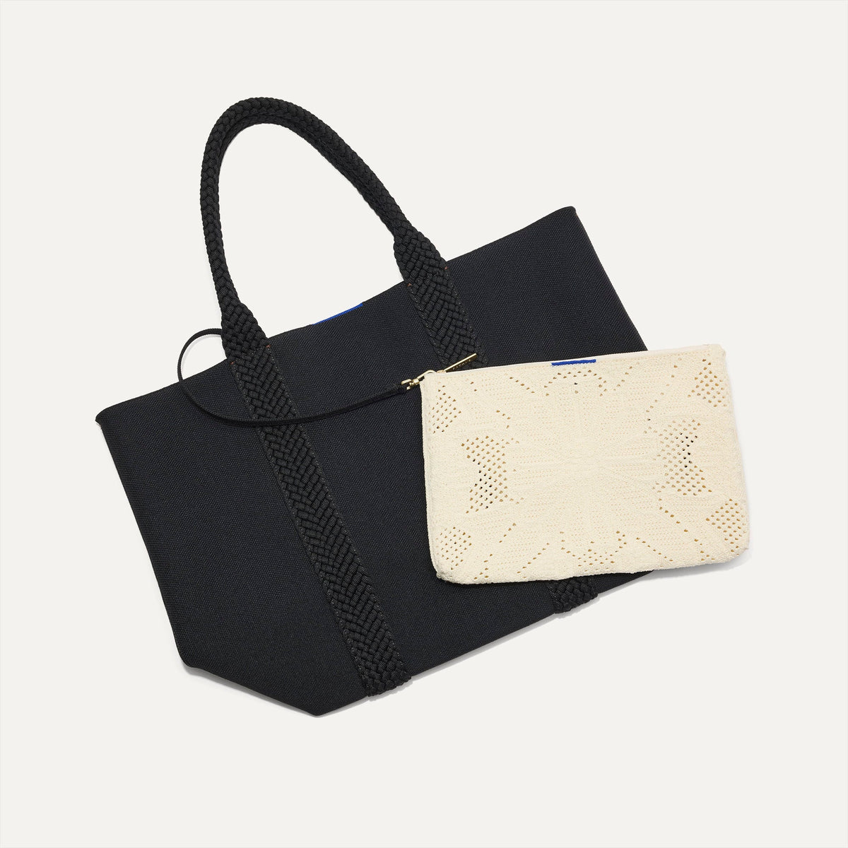 Overlay::Clips onto The Lightweight Tote key leash. | Alt:: The Convertible Clutch in Moonflower, focusing on the strap.