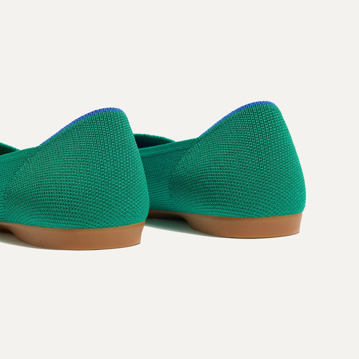 Close up of the heel of The Daily Flat in Clover, with Rothy's signature blue halo.