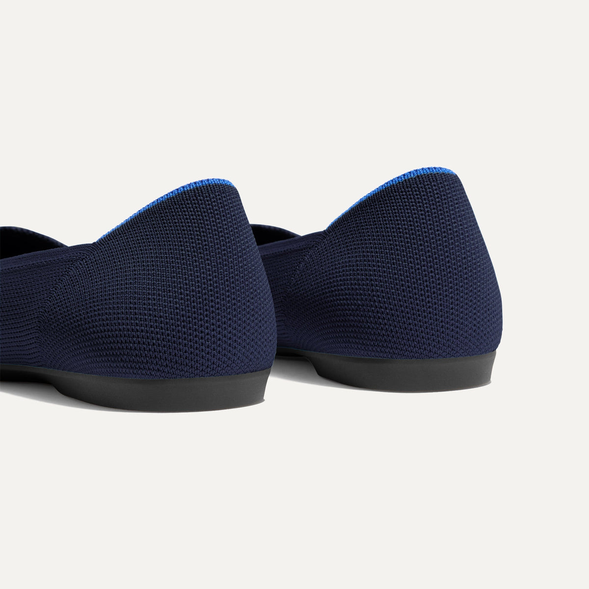 Close up of the heel of The Daily Flat in Navy, with Rothy's signature blue halo.