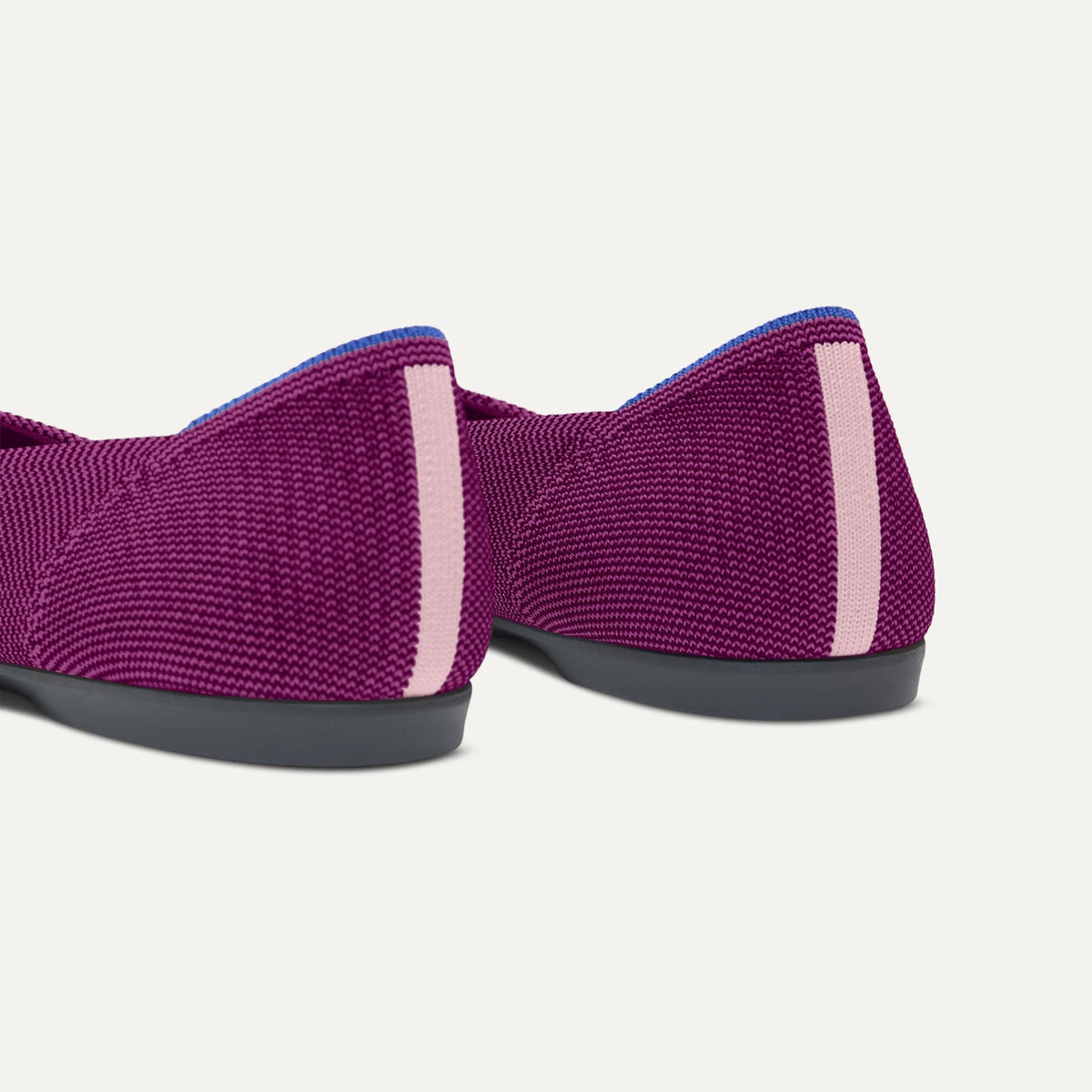 Close up of the heel of The Daily Flat in Wild Berry, with Rothy's signature blue halo.