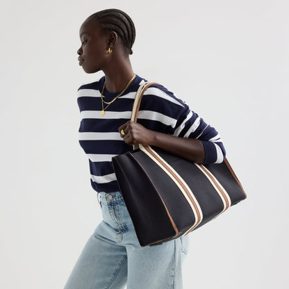 hover | The Classic Tote in Black Coffee, worn over the shoulder by a model, shown from the side.