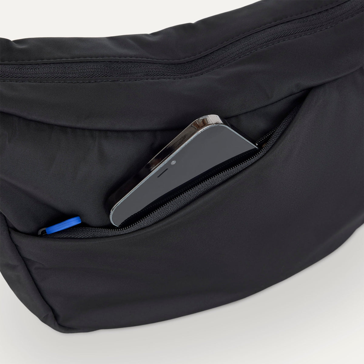 The Travel Sling in Ink shown closed from the top showcasing the side pocket.