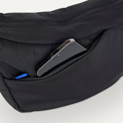 The Travel Sling in Ink shown closed from the top showcasing the side pocket.