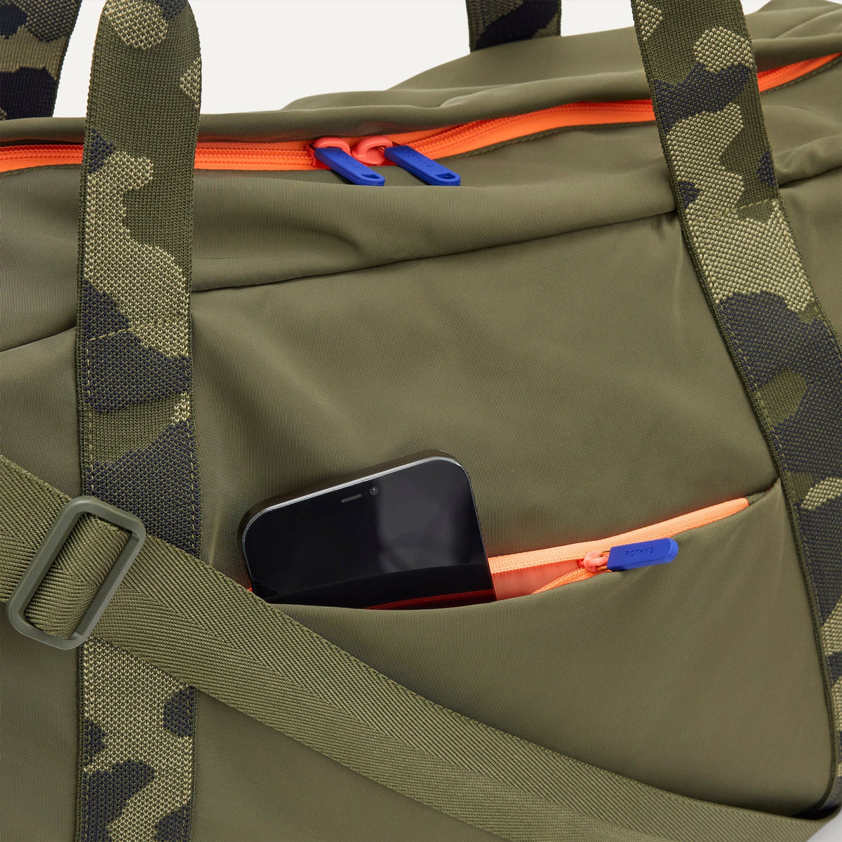 The Travel Duffle in Forest shown closed from the top, focusing on the side pocket.