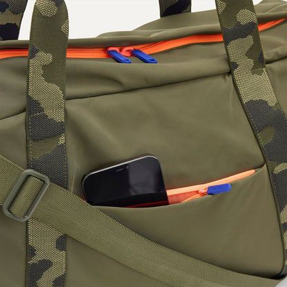 The Travel Duffle in Forest shown closed from the top, focusing on the side pocket.