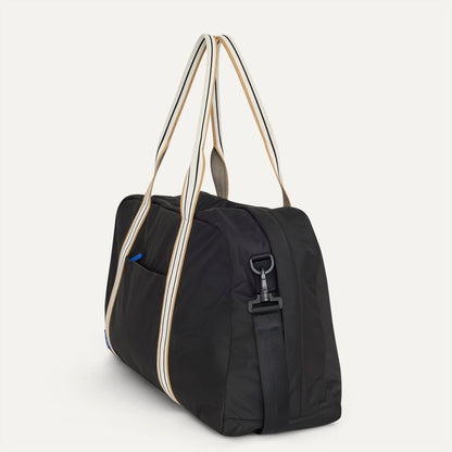 The Travel Duffle in Ink shown in diagonal view.