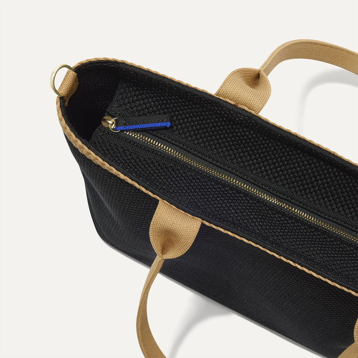 The Lightweight Zip Tote in Black Espresso Open-Knit, focusing on the zip closure and handles