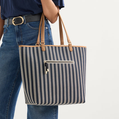 Alternate view of a model carrying The Two-Way Tote in Shadow showing the indigo striped side.