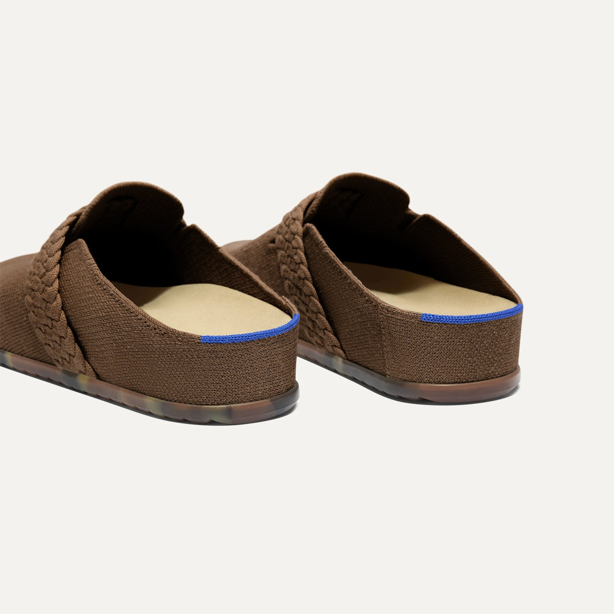 Close up of the heel of The Braid Clog in Acorn, with Rothy's signature blue halo.