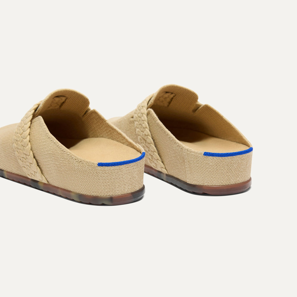 Close up of the heel of The Braid Clog in Wheat, with Rothy's signature blue halo.