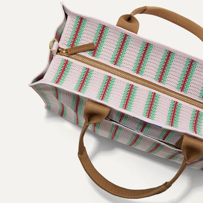The Classic Tote in Watermelon Market Stripe, shown from above, with the top zipper closed.
