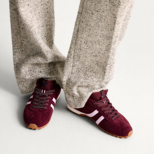 hover | Model wearing The Ivy Sneaker in ReVelvet Syrah.