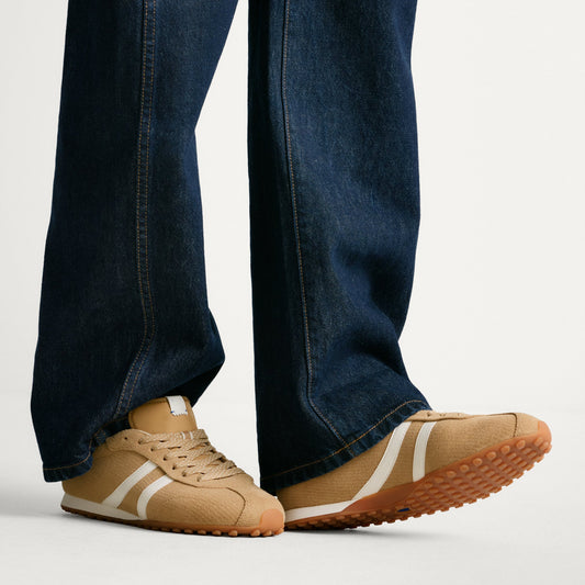 hover | Model wearing The Ivy Sneaker in ReVelvet Wren.