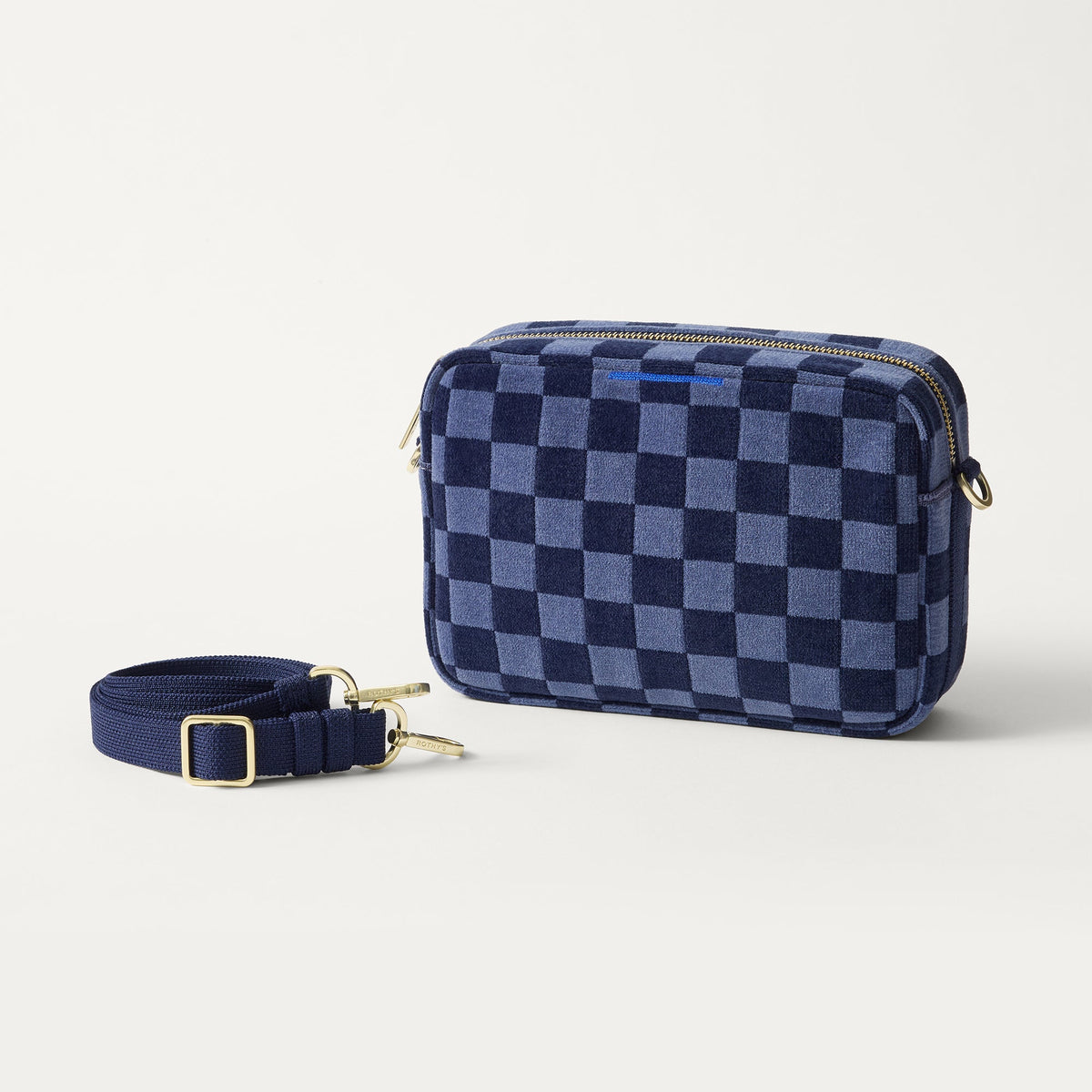 The Crossbody Camera Bag in ReVelvet™ Blue Ink shown by itself with removable strap.