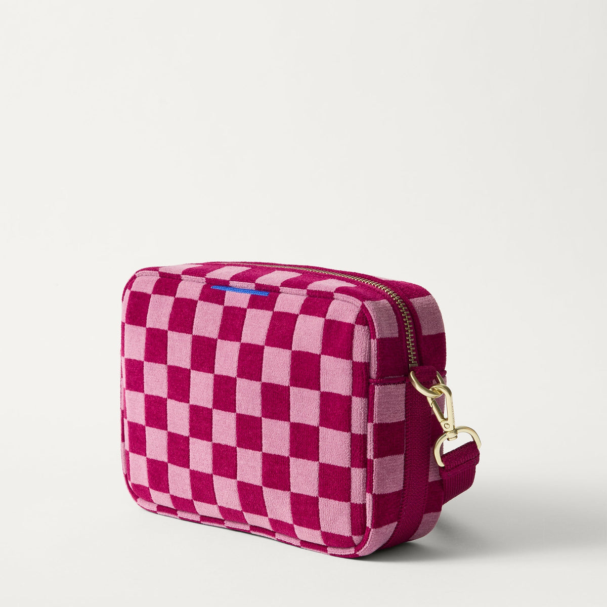 The Crossbody Camera Bag in ReVelvet™ Orchid, shown from the side.
